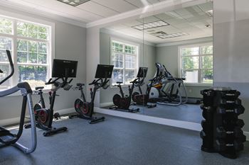 A room with exercise equipment and windows.